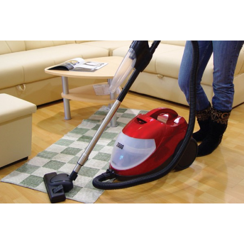 A person using a vacuum cleaner on the floor