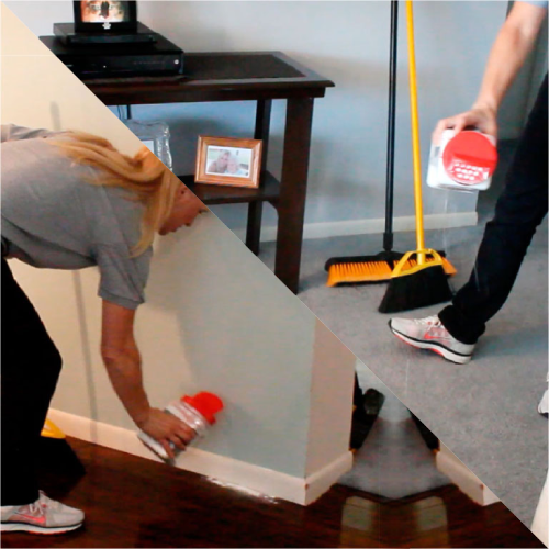 Two men are working together to clean up a room.